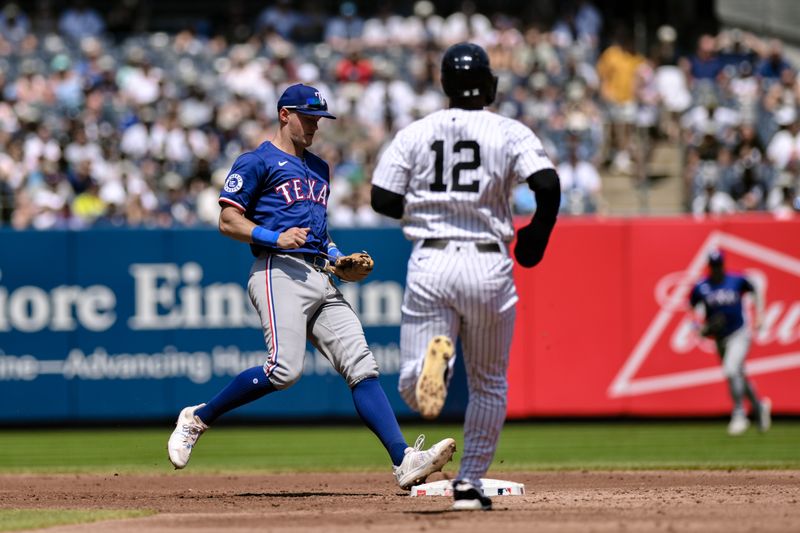 Aug 10, 2024; Bronx, New York, USA; Texas Rangers third baseman Josh Jung (6) gets a force out at second base against New York Yankees outfielder Trent Grisham (12) during the second inning at Yankee Stadium. Mandatory Credit: John Jones-USA TODAY Sports