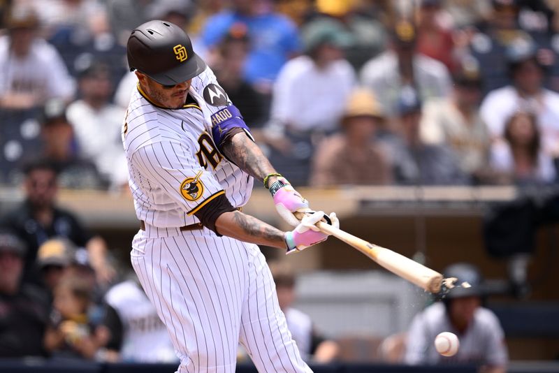 Aug 19, 2023; San Diego, California, USA; San Diego Padres designated hitter Manny Machado (13) breaks his bat during the third inning against the Arizona Diamondbacks at Petco Park. Mandatory Credit: Orlando Ramirez-USA TODAY Sports