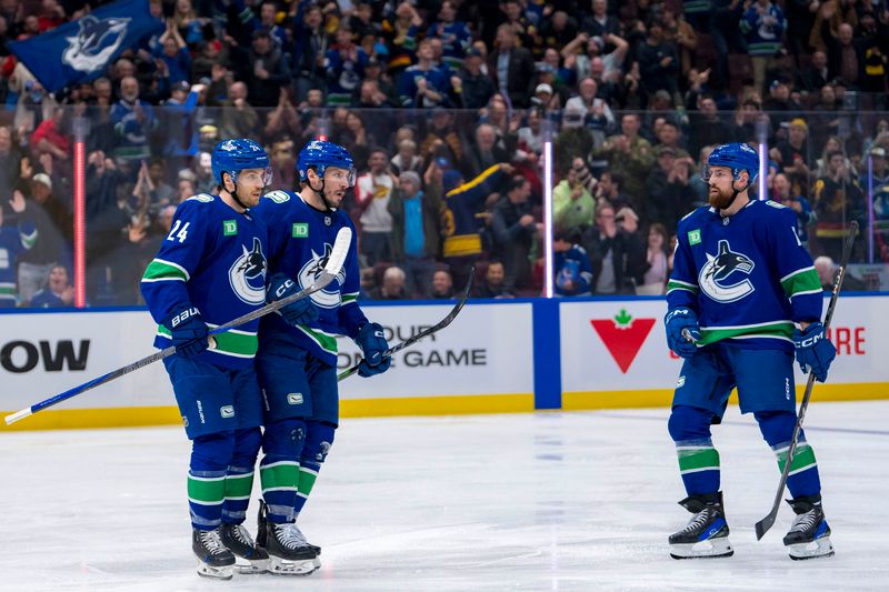 Nov 12, 2024; Vancouver, British Columbia, CAN; Vancouver Canucks forward Pius Suter (24), forward J.T. Miller (9) and defenseman Filip Hronek (17) celebrate Suter’s goal against the Calgary Flames during the second period at Rogers Arena. Mandatory Credit: Bob Frid-Imagn Images