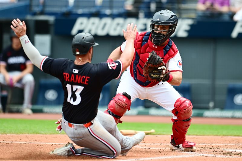 May 1, 2025; Cleveland, Ohio, USA; Cleveland Guardians catcher Austin Hedges (27) tags out Minnesota Twins first baseman Ty France (13) during the second inning at Progressive Field. Mandatory Credit: Ken Blaze-Imagn Images

