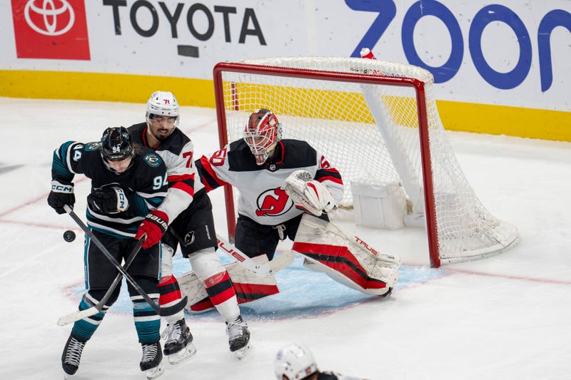 Feb 27, 2024; San Jose, California, USA;  San Jose Sharks left wing Alexander Barabanov (94) attempts to deflect the puck into the net against New Jersey Devils defenseman Jonas Siegenthaler (71) and New Jersey Devils goaltender Nico Daws (50) during the third period at SAP Center at San Jose. Mandatory Credit: Neville E. Guard-USA TODAY Sports