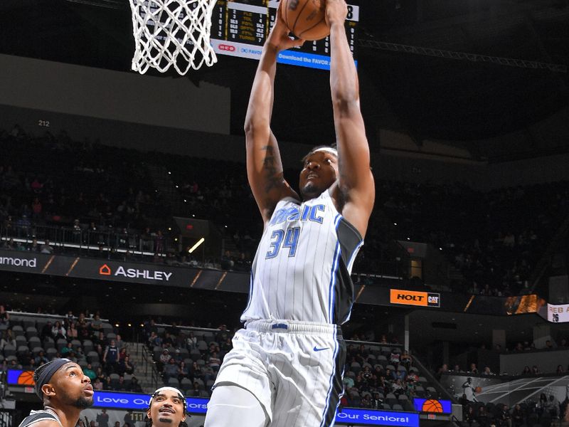 SAN ANTONIO, TX - MARCH 14: Wendell Carter Jr. #34 of the Orlando Magic dunks the ball during the game against the San Antonio Spurs on March 14, 2023 at the AT&T Center in San Antonio, Texas. NOTE TO USER: User expressly acknowledges and agrees that, by downloading and or using this photograph, user is consenting to the terms and conditions of the Getty Images License Agreement. Mandatory Copyright Notice: Copyright 2023 NBAE (Photos by Michael Gonzales/NBAE via Getty Images)