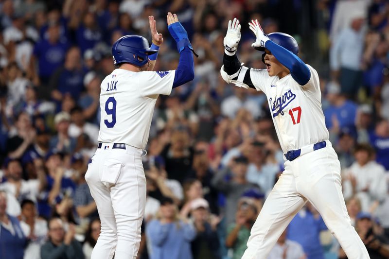 Jul 2, 2024; Los Angeles, California, USA;  Los Angeles Dodgers designated hitter Shohei Ohtani (17) is greeted by second baseman Gavin Lux (9) after hitting a two-run home run during the seventh inning against the Arizona Diamondbacks at Dodger Stadium. Mandatory Credit: Kiyoshi Mio-USA TODAY Sports