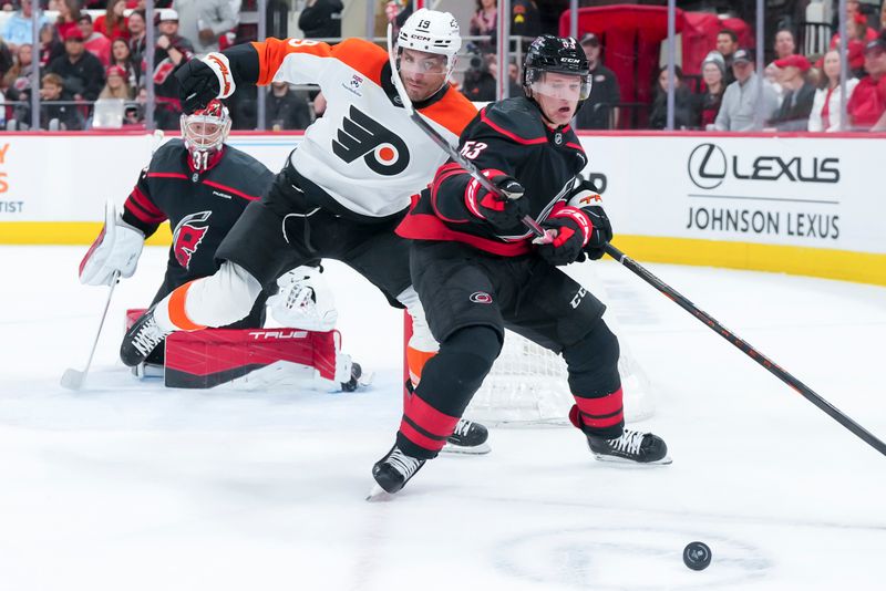 Oct 11, 2025; Raleigh, North Carolina, USA;  Philadelphia Flyers right wing Garnet Hathaway (19) and c55 battle over the puck during the second period at Lenovo Center. Mandatory Credit: James Guillory-Imagn Images