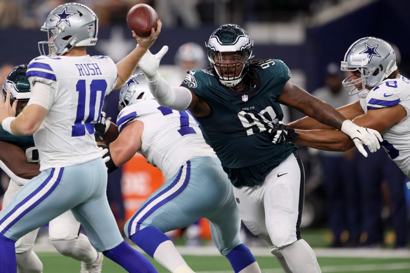 Philadelphia Eagles defensive tackle Jalen Carter (98) rushes as Dallas Cowboys' Cooper Rush (10) throws a pass in the first half of an NFL football game in Arlington, Texas, Sunday, Nov. 10, 2024. (AP Photo/Gareth Patterson)