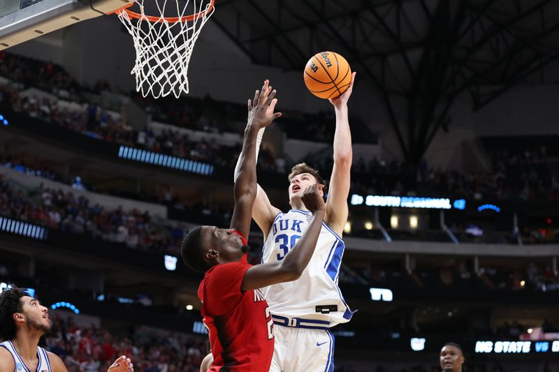 Mar 31, 2024; Dallas, TX, USA; Duke Blue Devils center Kyle Filipowski (30) shoots against North Carolina State Wolfpack forward Mohamed Diarra (23) in the second half in the finals of the South Regional of the 2024 NCAA Tournament at American Airline Center. Mandatory Credit: Tim Heitman-USA TODAY Sports