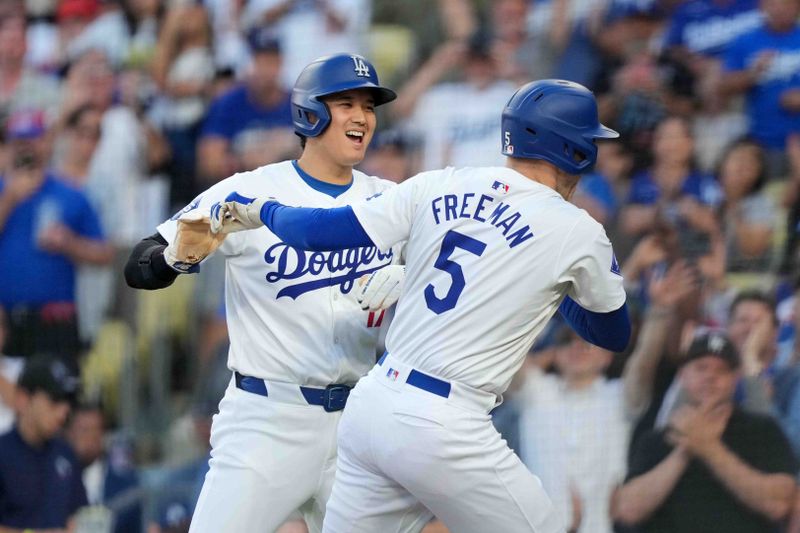 Jul 3, 2024; Los Angeles, California, USA; Los Angeles Dodgers first baseman Freddie Freeman (5) celebrates with  designated hitter Shohei Ohtani (17) after hitting a three-run home run in the first inning against the Arizona Diamondbacks at Dodger Stadium. Mandatory Credit: Kirby Lee-USA TODAY Sports