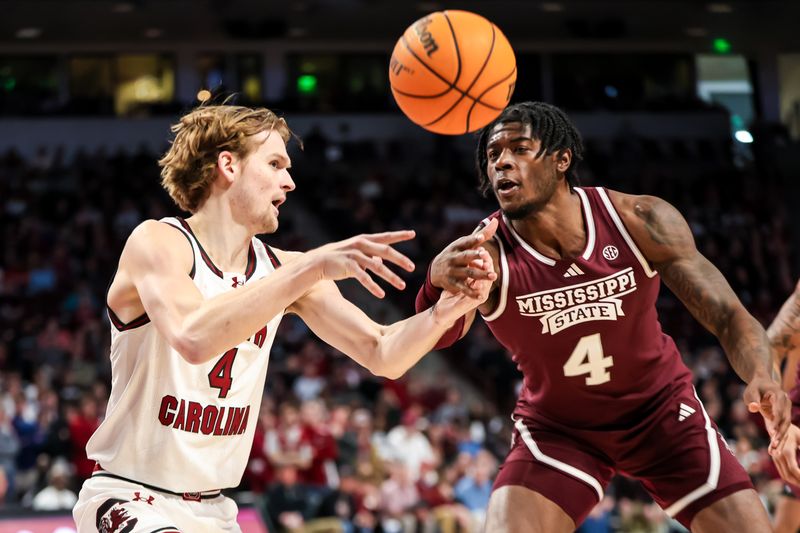 Jan 6, 2024; Columbia, South Carolina, USA; South Carolina Gamecocks forward Stephen Clark (4) and Mississippi State Bulldogs forward Cameron Matthews (4) battle for a loose ball in the first half at Colonial Life Arena. Mandatory Credit: Jeff Blake-USA TODAY Sports