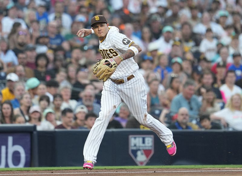 Jul 25, 2023; San Diego, California, USA;  San Diego Padres third baseman Manny Machado (13) throws out Pittsburgh Pirates right fielder Henry Davis (not pictured) at first base during the fourth inning at Petco Park. Mandatory Credit: Ray Acevedo-USA TODAY Sports