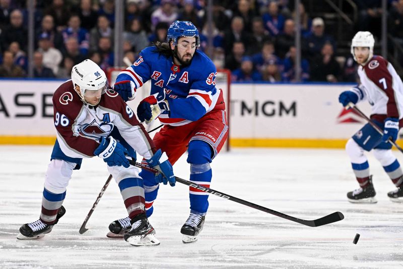 Feb 5, 2024; New York, New York, USA;  Colorado Avalanche right wing Mikko Rantanen (96) and home \93\ battle for the puck during the third period at Madison Square Garden. Mandatory Credit: Dennis Schneidler-USA TODAY Sports