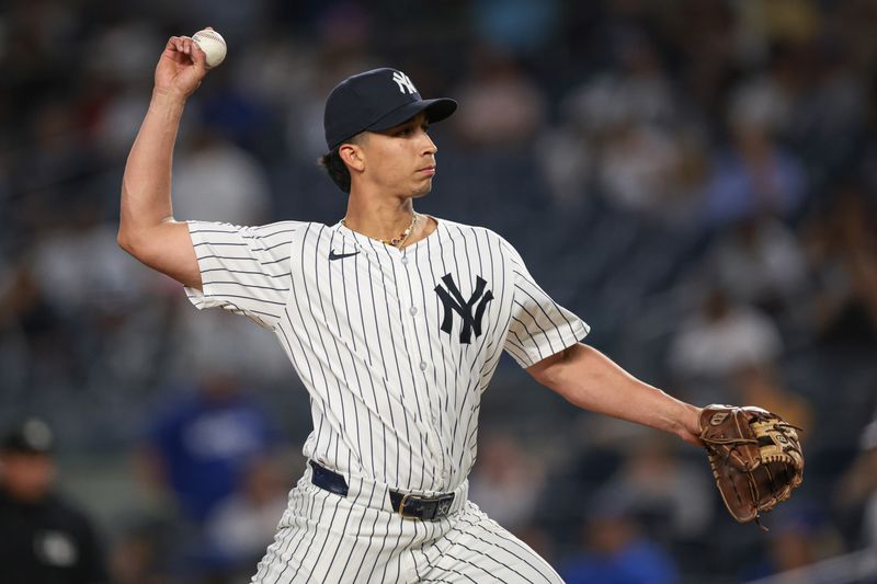 Jun 8, 2024; Bronx, New York, USA; New York Yankees position player Oswaldo Cabrera (95) delivers a pitch during the ninth inning against the Los Angeles Dodgers at Yankee Stadium. Mandatory Credit: Vincent Carchietta-USA TODAY Sports