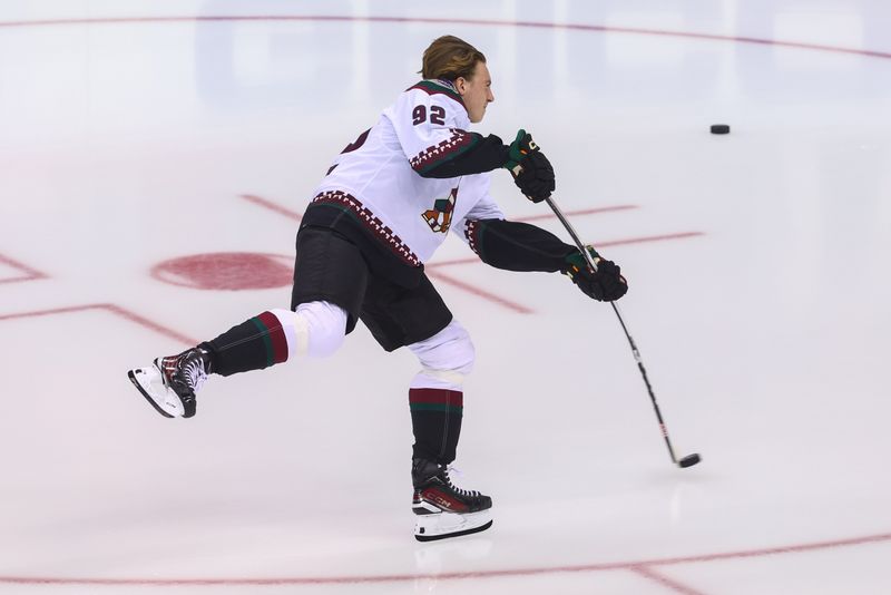 Oct 13, 2023; Newark, New Jersey, USA; Arizona Coyotes center Logan Cooley (92) takes his rookie lap before the start of his first NHL game against the New Jersey Devils at Prudential Center. Mandatory Credit: Ed Mulholland-USA TODAY Sports