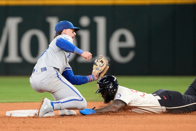 Jun 21, 2024; Arlington, Texas, USA; Kansas City Royals shortstop Bobby Witt Jr. (7) tags out Texas Rangers right fielder Ardolis Garcia (53) while attempting to steal second base during the eighth inning at Globe Life Field. Mandatory Credit: Jim Cowsert-USA TODAY Sports