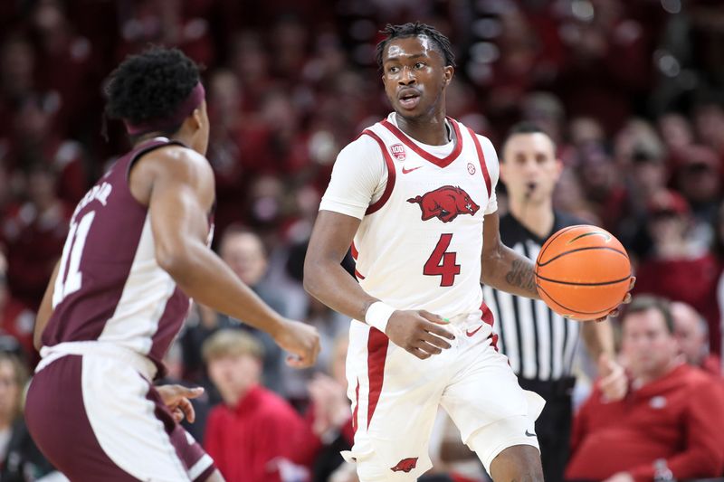 Feb 11, 2023; Fayetteville, Arkansas, USA; Arkansas Razorbacks guard Davonte Davis (4) dribbles in the first half against the Mississippi State Bulldogs at Bud Walton Arena. Bulldogs won 70-64. Mandatory Credit: Nelson Chenault-USA TODAY Sports