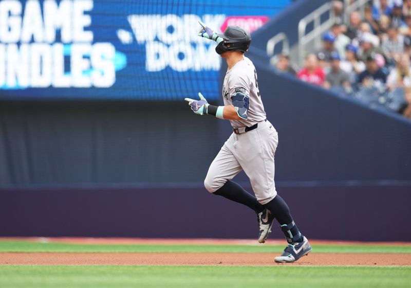 Jun 30, 2024; Toronto, Ontario, CAN; New York Yankees designated hitter Aaron Judge (99) celebrates after hitting a two run home run against the Toronto Blue Jays during the first inning at Rogers Centre. Mandatory Credit: Nick Turchiaro-USA TODAY Sports