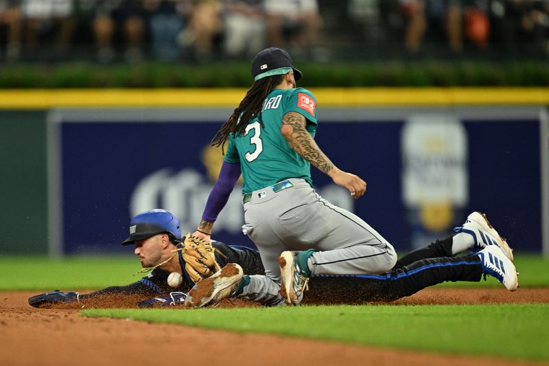 Jul 11, 2025; Detroit, Michigan, USA;  Detroit Tigers third baseman Zach McKinstry (39) slides safely into second base for a steal after the throw got away from Seattle Mariners shortstop J.P. Crawford (3) in the sixth inning at Comerica Park. Mandatory Credit: Lon Horwedel-Imagn Images