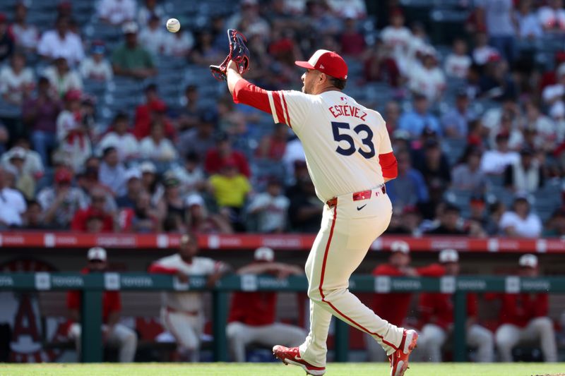 Jun 9, 2024; Anaheim, California, USA;  Los Angeles Angels relief pitcher Carlos Estevez (53) fields a ground ball during the ninth inning against the Houston Astros at Angel Stadium. Mandatory Credit: Kiyoshi Mio-USA TODAY Sports