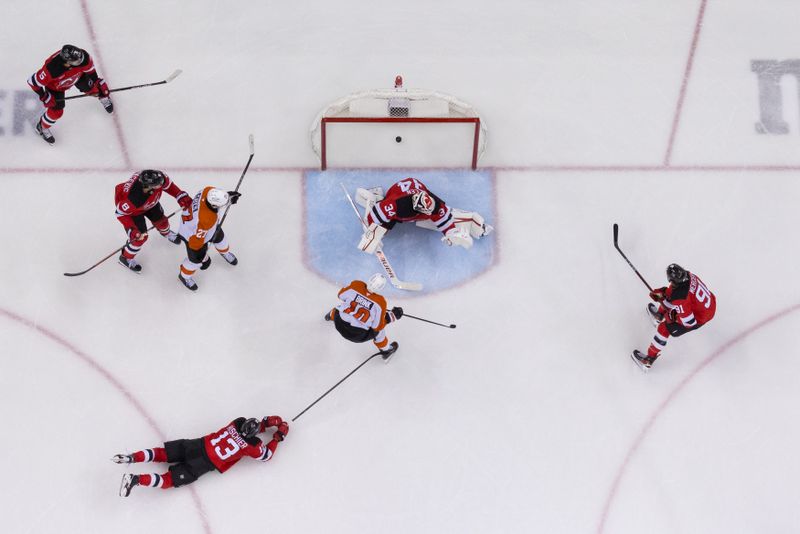 Jan 18, 2025; Newark, New Jersey, USA; Philadelphia Flyers right wing Bobby Brink (10) scores a goal on New Jersey Devils goaltender Jake Allen (34) during the third period at Prudential Center. Mandatory Credit: Ed Mulholland-Imagn Images