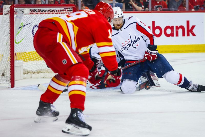 Mar 18, 2024; Calgary, Alberta, CAN; Washington Capitals defenseman Nick Jensen (3) blocks a shot by Calgary Flames during the second period at Scotiabank Saddledome. Mandatory Credit: Sergei Belski-USA TODAY Sports