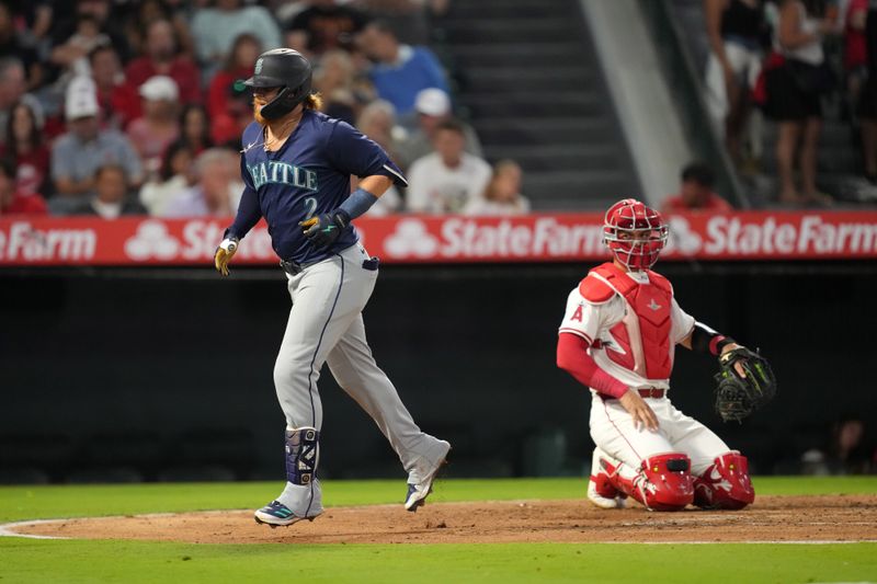 Aug 31, 2024; Anaheim, California, USA; Seattle Mariners first baseman Justin Turner (2) crosses home plate after hitting a home run in the third inning as Los Angeles Angels catcher Logan O'Hoppe (14) watches at Angel Stadium. Mandatory Credit: Kirby Lee-USA TODAY Sports