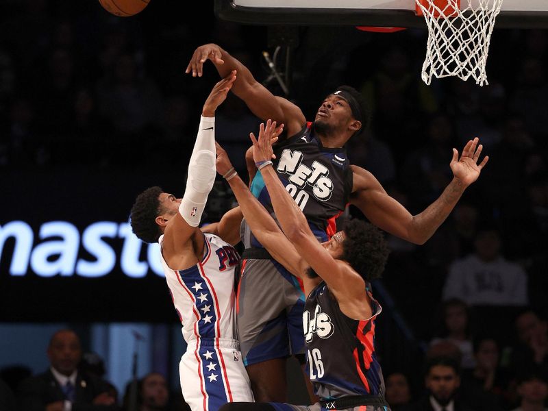 NEW YORK, NEW YORK - NOVEMBER 19:  Royce O'Neale #00 of the Brooklyn Nets blocks a shot by Tobias Harris #12 of the Philadelphia 76ers as Spencer Dinwiddie #26 of the Brooklyn Nets defends in the first half at Barclays Center on November 19, 2023 in the Brooklyn borough of New York City. NOTE TO USER: User expressly acknowledges and agrees that, by downloading and or using this photograph, User is consenting to the terms and conditions of the Getty Images License Agreement. (Photo by Elsa/Getty Images)