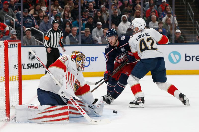 Mar 5, 2026; Columbus, Ohio, USA; Florida Panthers goalie Daniil Tarasov (40) makes a save as Columbus Blue Jackets center Mathieu Olivier (24) looks for a rebound during the second period at Nationwide Arena. Mandatory Credit: Russell LaBounty-Imagn Images