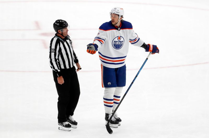 Mar 10, 2024; Pittsburgh, Pennsylvania, USA;  Edmonton Oilers defenseman Vincent Desharnais (73) protests to linesman Jonny Murray (95) after being called for roughing against the Pittsburgh Penguins during the third period at PPG Paints Arena. The Oilers won 4-0. Mandatory Credit: Charles LeClaire-USA TODAY Sports