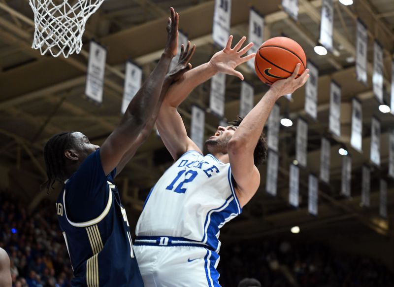 Dec 31, 2025; Durham, North Carolina, USA; Duke Blue Devils forward Cameron Boozer (12) shoots over Georgia Tech Yellow Jackets forward Baye Ndongo (11) during the second half at Cameron Indoor Stadium.   The Blue Devils won 85-79.  Mandatory Credit: Rob Kinnan-Imagn Images