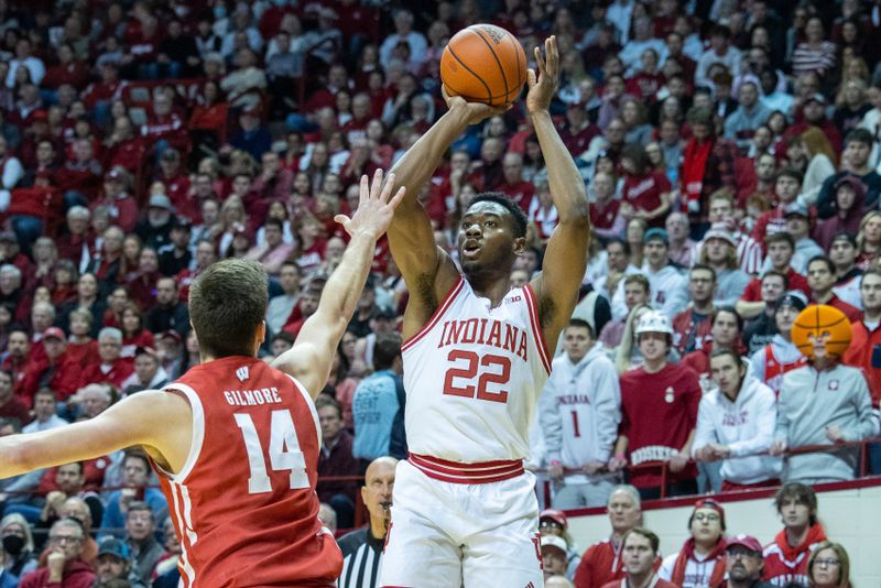 Jan 14, 2023; Bloomington, Indiana, USA; Indiana Hoosiers forward Jordan Geronimo (22) shoots the ball while Wisconsin Badgers forward Carter Gilmore (14) defends in the first half at Simon Skjodt Assembly Hall. Mandatory Credit: Trevor Ruszkowski-USA TODAY Sports