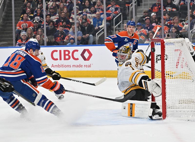 Dec 31, 2025; Edmonton, Alberta, CAN;  Edmonton Oilers left winger Zach Hyman (18) shoots on Boston Bruins goalie Jeremy Swayman (1) during the first period at Rogers Place. Mandatory Credit: Walter Tychnowicz-Imagn Images