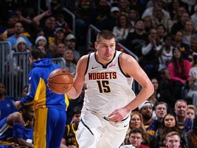 DENVER, CO - DECEMBER 25: Nikola Jokic #15 of the Denver Nuggets dribbles the ball during the game against the Golden State Warriors on December 25, 2023 at the Ball Arena in Denver, Colorado. NOTE TO USER: User expressly acknowledges and agrees that, by downloading and/or using this Photograph, user is consenting to the terms and conditions of the Getty Images License Agreement. Mandatory Copyright Notice: Copyright 2023 NBAE (Photo by Garrett Ellwood/NBAE via Getty Images)