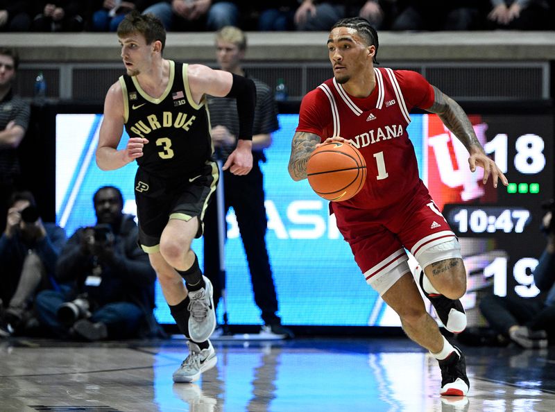 Feb 25, 2023; West Lafayette, Indiana, USA; Indiana Hoosiers guard Jalen Hood-Schifino (1) dribbles the ball against Purdue Boilermakers guard Braden Smith (3) during the first half at Mackey Arena. Mandatory Credit: Marc Lebryk-USA TODAY Sports