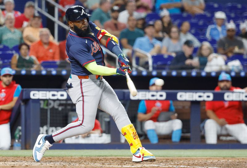 Sep 21, 2024; Miami, Florida, USA;  Atlanta Braves designated hitter Marcell Ozuna (20) hits a single against the Miami Marlins in the third inning at loanDepot Park. Mandatory Credit: Rhona Wise-Imagn Images