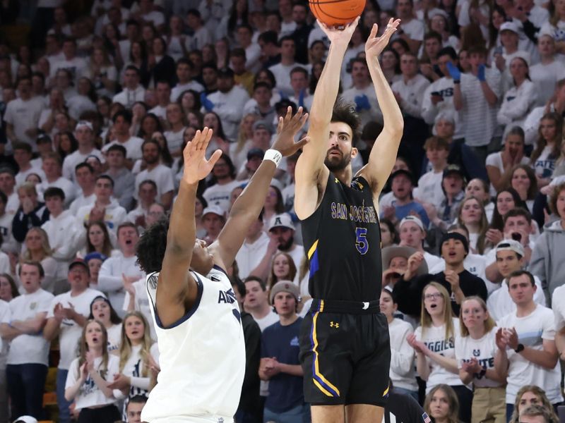 Jan 30, 2024; Logan, Utah, USA; San Jose State Spartans forward Tibet Gorener (5) takes a three point shot over Utah State Aggies forward Great Osobor (1) during the first half at Dee Glen Smith Spectrum. Mandatory Credit: Rob Gray-USA TODAY Sports