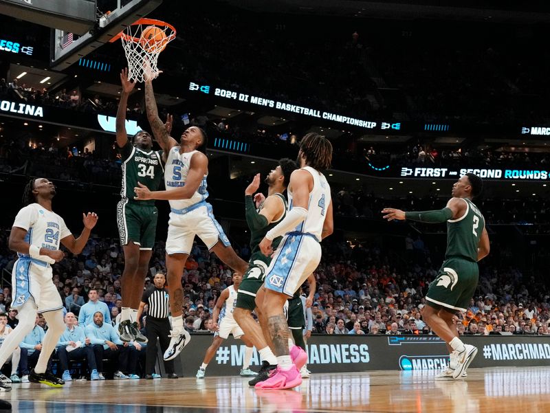 March 23, 2024, Charlotte, NC, USA; North Carolina Tar Heels forward Armando Bacot (5) shoots against North Carolina Tar Heels forward Duwe Farris (34)  in the second round of the 2024 NCAA Tournament at the Spectrum Center. Mandatory Credit: Jim Dedmon-USA TODAY Sports