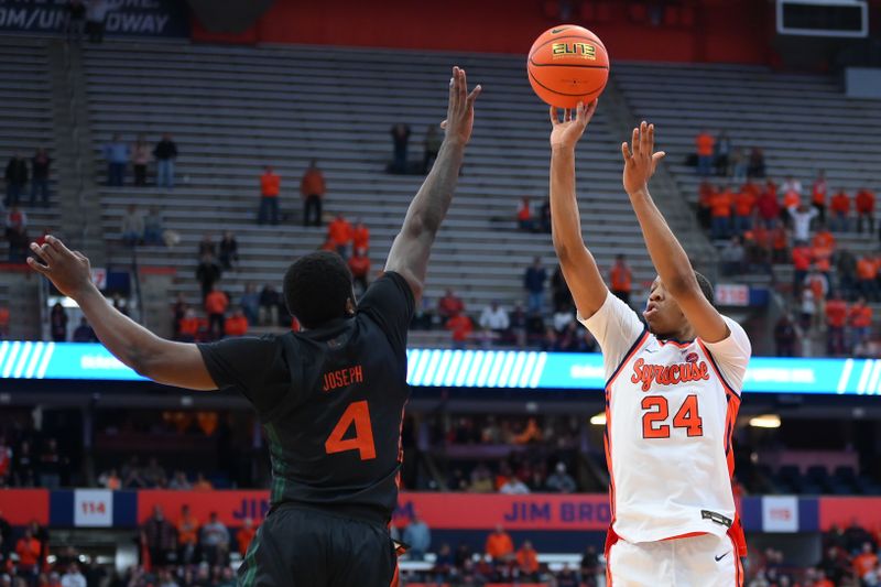 Jan 20, 2024; Syracuse, New York, USA; Syracuse Orange guard Quadir Copeland (24) takes the game-winning shot as Miami (Fl) Hurricanes guard Bensley Joseph (4) defends during the second half at the JMA Wireless Dome. Mandatory Credit: Rich Barnes-USA TODAY Sports