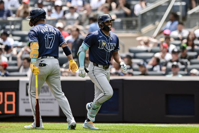 Jul 21, 2024; Bronx, New York, USA; Tampa Bay Rays outfielder Richie Palacios (1) is greeted at home plate by Tampa Bay Rays third baseman Isaac Paredes (17) after hitting a solo home run against the New York Yankees at Yankee Stadium. Mandatory Credit: John Jones-USA TODAY Sports