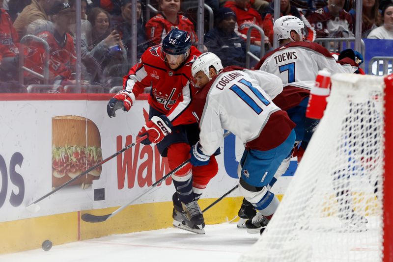 Feb 13, 2024; Washington, District of Columbia, USA; Washington Capitals right wing Nic Dowd (26) and Colorado Avalanche center Andrew Cogliano (11) battle for the puck in the third period at Capital One Arena. Mandatory Credit: Geoff Burke-USA TODAY Sports