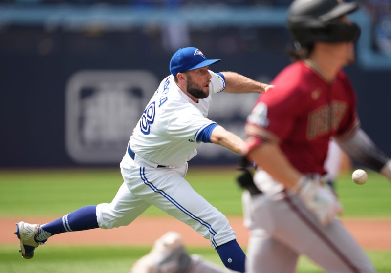 Jul 16, 2023; Toronto, Ontario, CAN; Toronto Blue Jays relief pitcher Tim Mayza (58) throws a ball to first base for the third out against the Arizona Diamondbacks during the sixth inning at Rogers Centre. Mandatory Credit: Nick Turchiaro-USA TODAY Sports