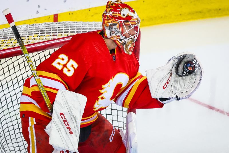 Mar 4, 2024; Calgary, Alberta, CAN; Calgary Flames goaltender Jacob Markstrom (25) makes a save during the warmup period against the Seattle Kraken at Scotiabank Saddledome. Mandatory Credit: Sergei Belski-USA TODAY Sports