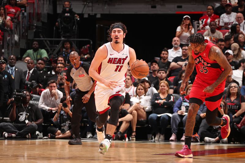 MIAMI, FL - APRIL 12:  Jaime Jaquez Jr. #11 of the Miami Heat dribbles the ball during the game against the Toronto Raptors on April 12, 2024 at Kaseya Center in Miami, Florida. NOTE TO USER: User expressly acknowledges and agrees that, by downloading and or using this Photograph, user is consenting to the terms and conditions of the Getty Images License Agreement. Mandatory Copyright Notice: Copyright 2024 NBAE (Photo by Issac Baldizon/NBAE via Getty Images)