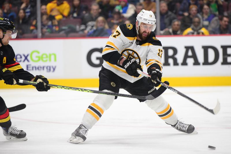 Feb 25, 2023; Vancouver, British Columbia, CAN; Boston Bruins forward Nick Foligno (17) reaches for the puck against the Vancouver Canucks during the second period at Rogers Arena. Mandatory Credit: Anne-Marie Sorvin-USA TODAY Sports