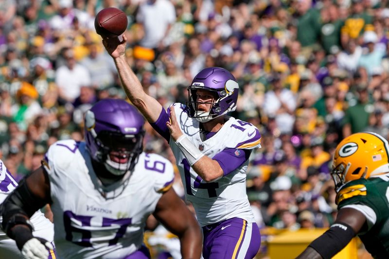 Minnesota Vikings quarterback Sam Darnold (14) throws a pass during the first half of an NFL football game against the Green Bay Packers, Sunday, Sept. 29, 2024, in Green Bay, Wis. (AP Photo/Morry Gash)