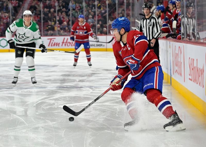 Feb 10, 2024; Montreal, Quebec, CAN; Montreal Canadiens forward Nick Suzuki (14) controls the puck against the Dallas Starsduring the second period at the Bell Centre. Mandatory Credit: Eric Bolte-USA TODAY Sports