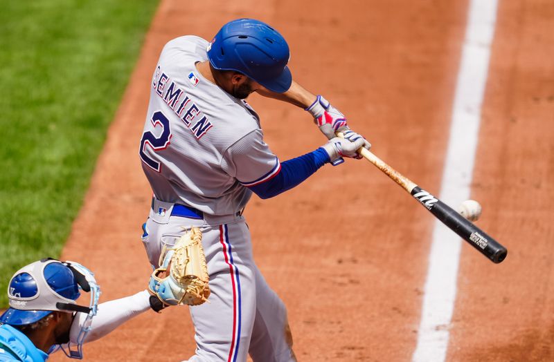 Apr 19, 2023; Kansas City, Missouri, USA; Texas Rangers second baseman Marcus Semien (2) hits an RBI single during the fourth inning against the Kansas City Royals at Kauffman Stadium. Mandatory Credit: Jay Biggerstaff-USA TODAY Sports