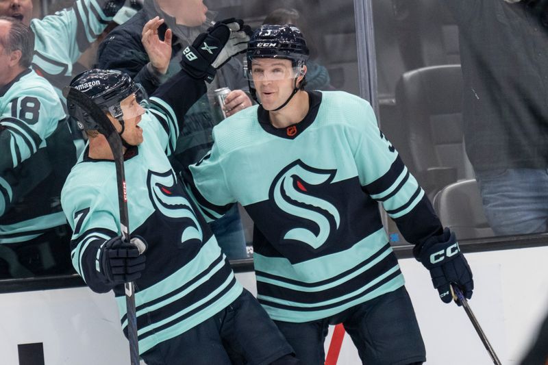 Feb 23, 2023; Seattle, Washington, USA; Seattle Kraken forward Jaden Schwartz (17) is congratulated by Seattle Kraken defenseman Will Borgen (3) after scoring a goal during the third period against the Boston Bruins at Climate Pledge Arena. Mandatory Credit: Stephen Brashear-USA TODAY Sports