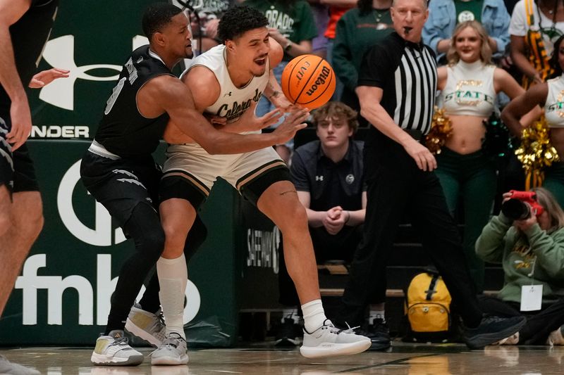 Feb 27, 2024; Fort Collins, Colorado, USA; Nevada Wolf Pack guard Hunter McIntosh (0) knocks the ball from Colorado State Rams forward Joel Scott (1) during the first half at Moby Arena. Mandatory Credit: Michael Madrid-USA TODAY Sports