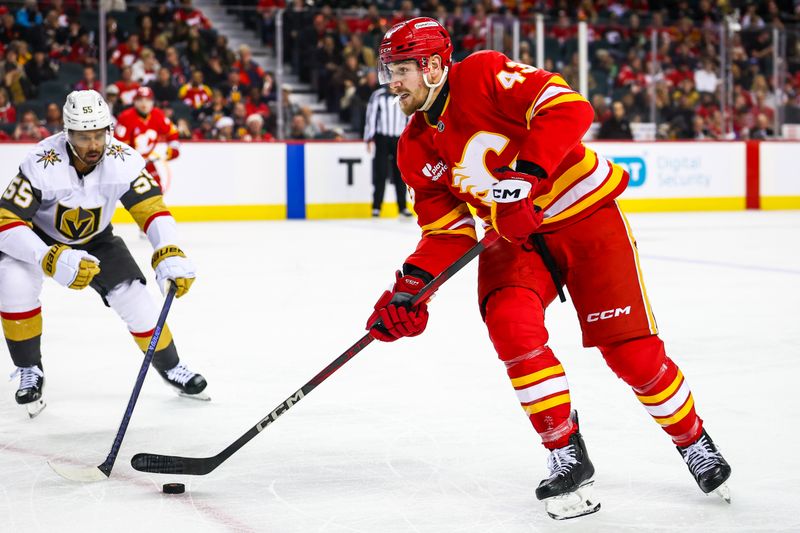 Dec 20, 2025; Calgary, Alberta, CAN; Calgary Flames right wing Adam Klapka (43) controls the puck against Vegas Golden Knights right wing Keegan Kolesar (55) during the second period at Scotiabank Saddledome. Mandatory Credit: Sergei Belski-Imagn Images