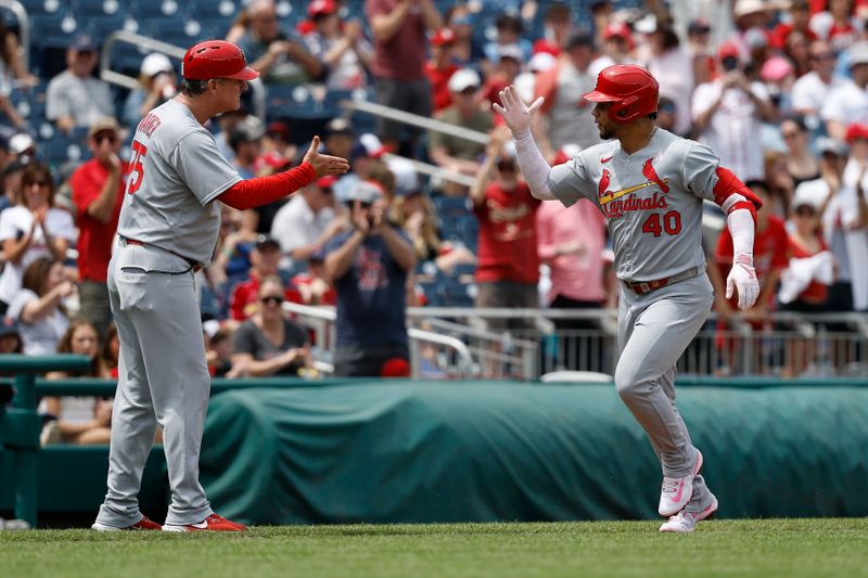 May 11, 2025; Washington, District of Columbia, USA; St. Louis Cardinals first base Willson Contreras (40) celebrates with Cardinals third base coach Ron 'Pop' Warner (75) while rounding the bases after hitting a solo home run against the Washington Nationals during the second inning at Nationals Park. Mandatory Credit: Geoff Burke-Imagn Images