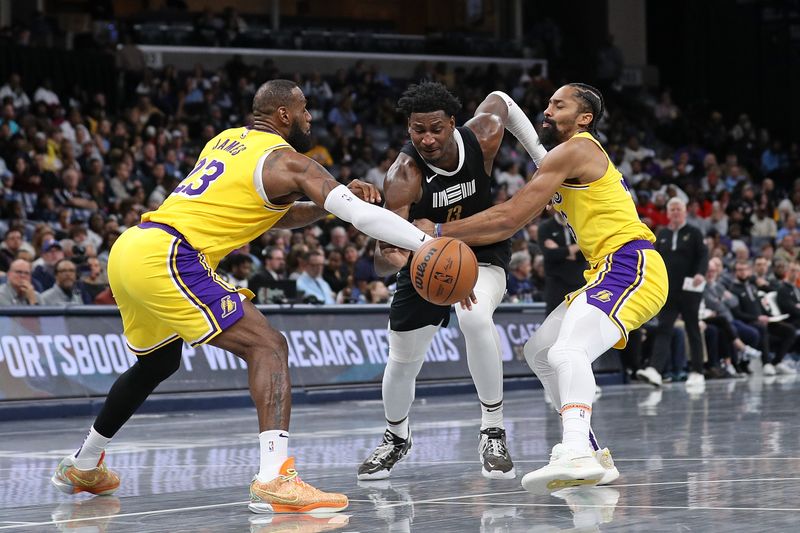 MEMPHIS, TENNESSEE - MARCH 27: Jaren Jackson Jr. #13 of the Memphis Grizzlies drives to the basket between LeBron James #23 of the Los Angeles Lakers and Spencer Dinwiddie #26 during the second half at FedExForum on March 27, 2024 in Memphis, Tennessee. NOTE TO USER: User expressly acknowledges and agrees that, by downloading and or using this photograph, User is consenting to the terms and conditions of the Getty Images License Agreement. (Photo by Justin Ford/Getty Images)